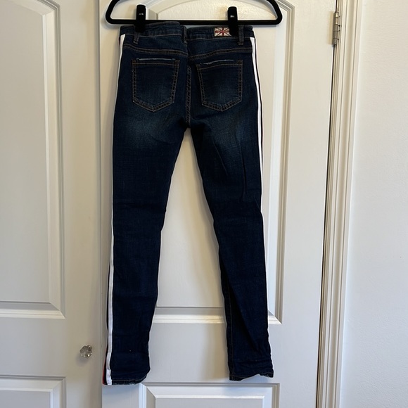 Dark blue jeans with rips by knees. Red, white & navy stripe detail along sides - Picture 3 of 3